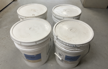 4 unopened buckets of white interior paint, 5 gallons each — 20 gallons total. All buckets are sealed and unused